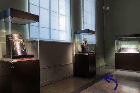 Go over to one of the glass displays near the window